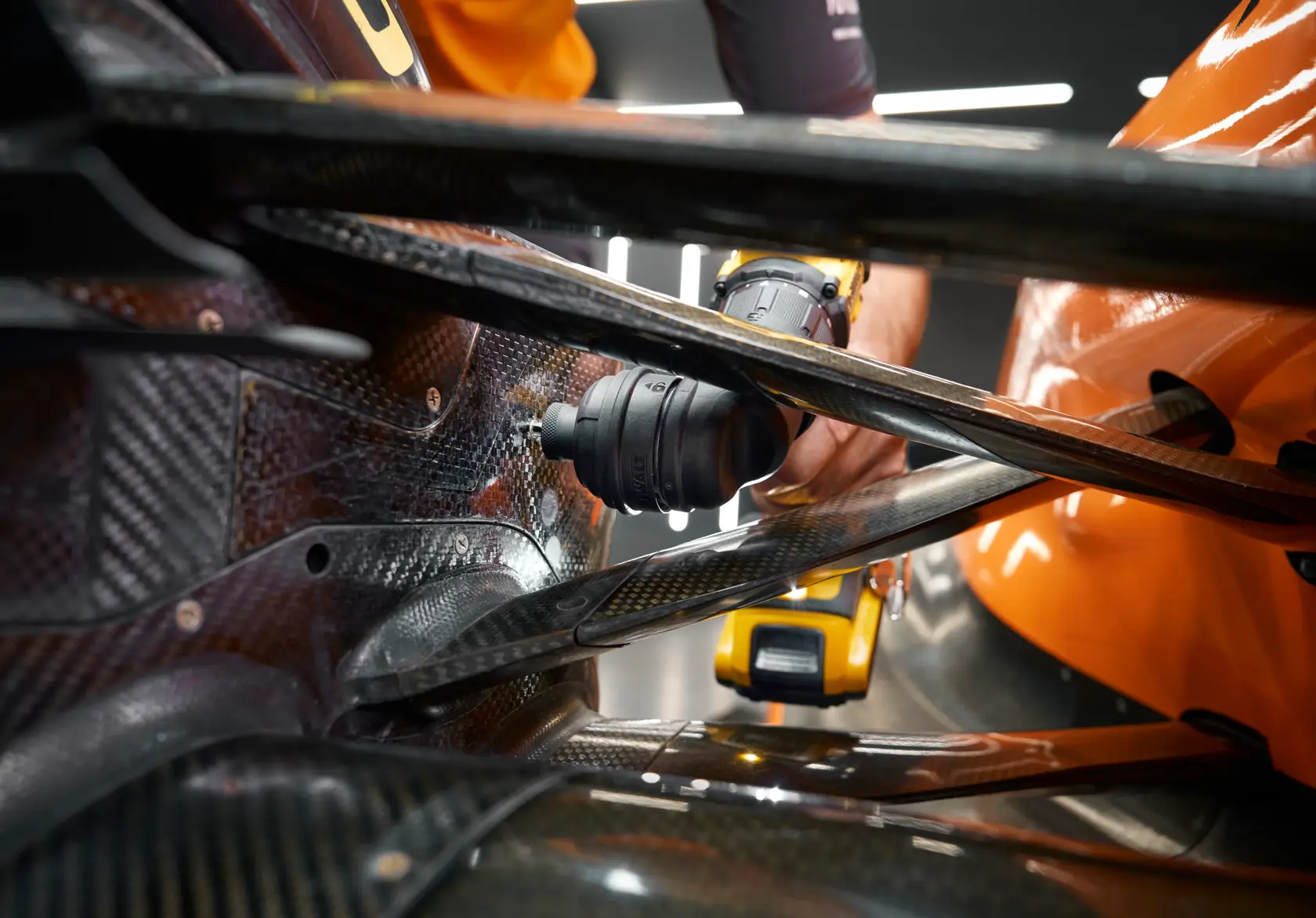 DEWALT DCD803D2T-QW, DCD803D2T in use on a car part. Photography product category. Close-up view.