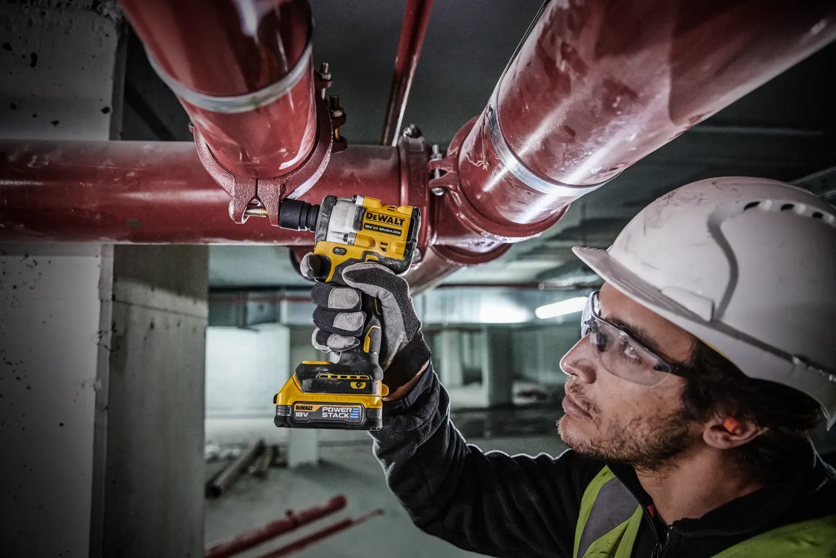 DEWALT cordless impact wrench set including a yellow and black impact wrench, two 18V Powerstack batteries, a battery charger, and a hard carrying case with DEWALT logo.