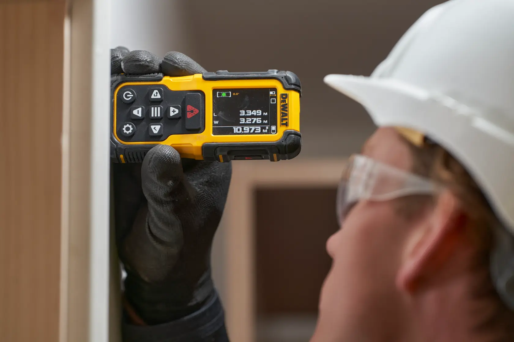 Image of a DEWALT handheld electronic device with a screen and multiple buttons. The image highlights its features: long range, reliable visibility, IP65 rating, haptic feedback, versatile operation, high accuracy, and easy recharge. There is also a USB logo indicating USB compatibility.